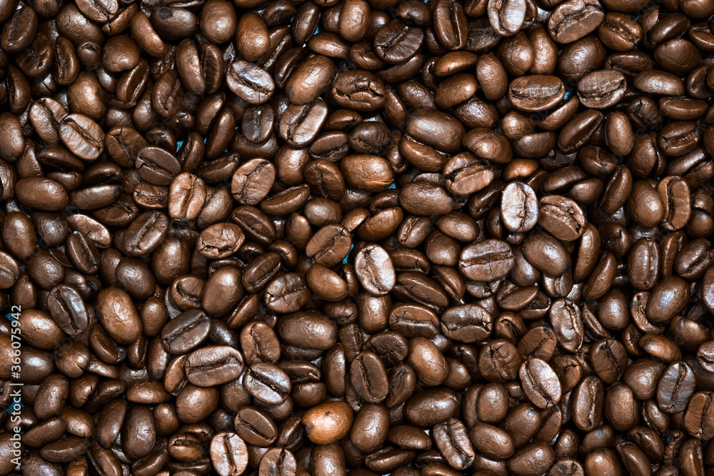 Naklejka premium Top view of brown roasted coffee beans, can be use as background, copy space for text.