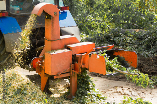 Industrial equipment, shredder of cut branches and twigs in operation. Wood Chipper.