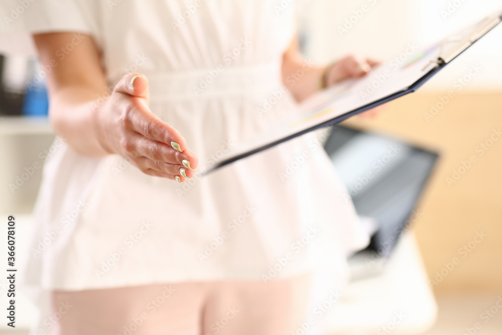 Obraz premium Close up cropped head of female medical worker standing in hospital and holding clipboard for noting information