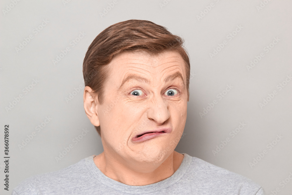 Portrait of funny crazy weird mature man making goofy grimace Portrait of funny crazy weird mature man making goofy grimace