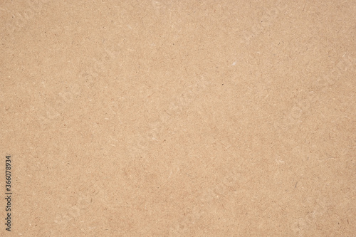 Texture of brown craft or kraft paper background, cardboard sheet, recycle paper, copy space for text. © tonstock
