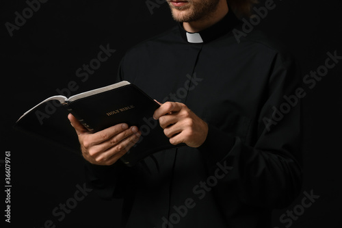 Handsome priest with Bible ...