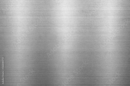 Silver metal texture of brushed stainless steel plate with the reflection of light.