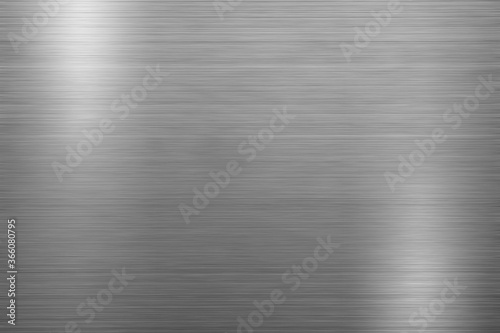 Silver metal texture of brushed stainless steel plate with the reflection of light.