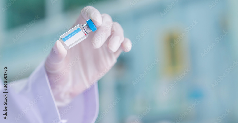 close up on scientist hand holding vaccine bottle for medical sample set at pharmaceutical operation room or scientific laboratory for fight and protect coronavirus (MERS-n COV) concept	