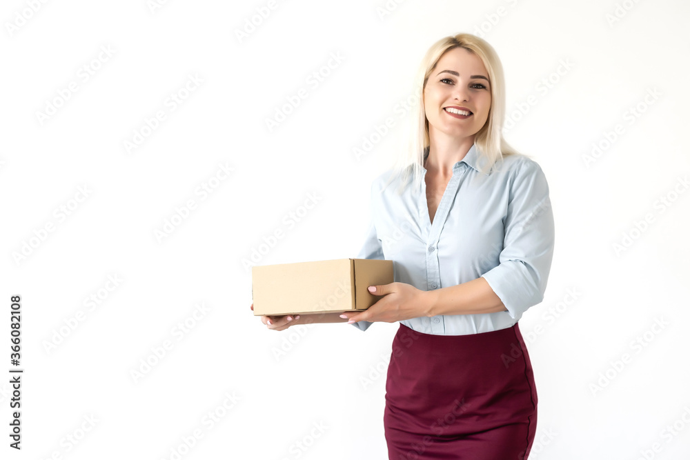 A young beautiful caucasian woman holding a box in her hands. A young beautiful caucasian woman holding a box in her hands.