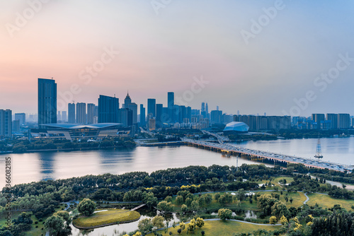 Dusk scenery of Shengjing Theater and urban buildings along the Hun River in Shenyang, Liaoning, China photo