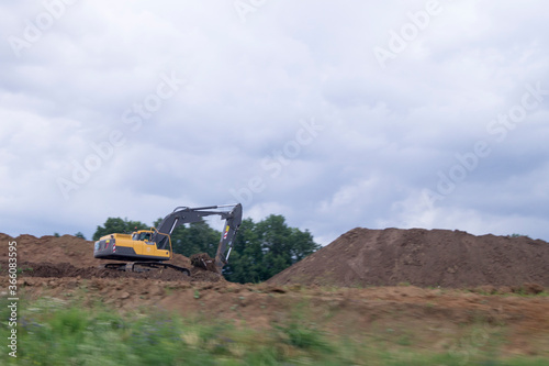an excavator removes soil in a quarry