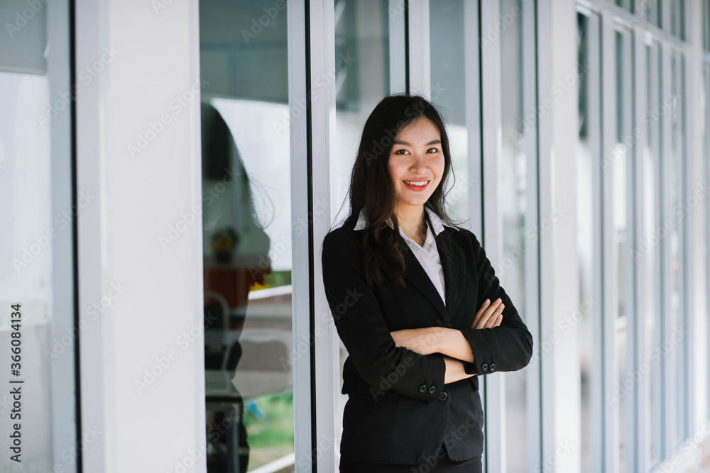 A smiling Asian business woman in white shirt crossed her arms A smiling Asian business woman in white shirt crossed her arms
