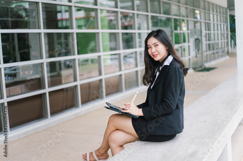 Beautiful young asian woman holding tablet pc