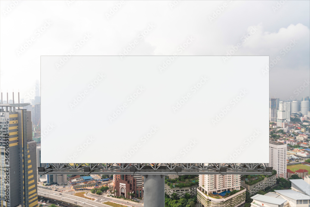 Fototapeta premium Blank white road billboard with KL cityscape background at day time. Street advertising poster, mock up, 3D rendering. Front view. The concept of marketing communication to promote or sell idea.