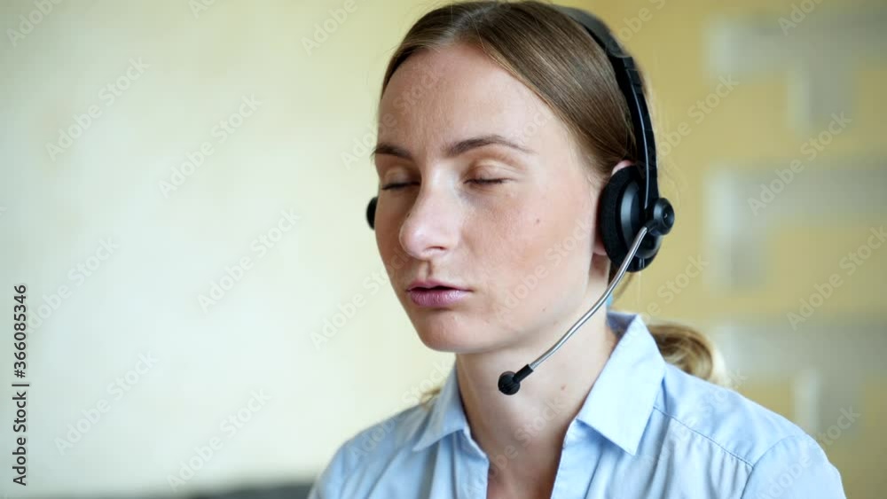 businesswoman talking on the phone while working on her computer at the office. Call сenter agent working on hotline businesswoman talking on the phone while working on her computer at the office. Call сenter agent working on hotline