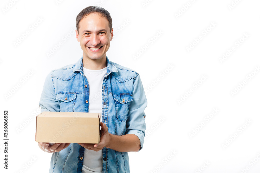 smiling delivery man holding a big parcel isolated on white smiling delivery man holding a big parcel isolated on white
