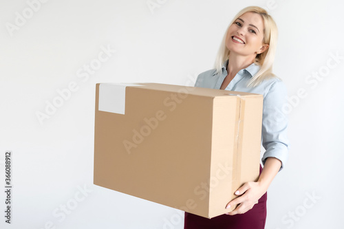 picture of attractive businesswoman delivering cardboard box © Angelov