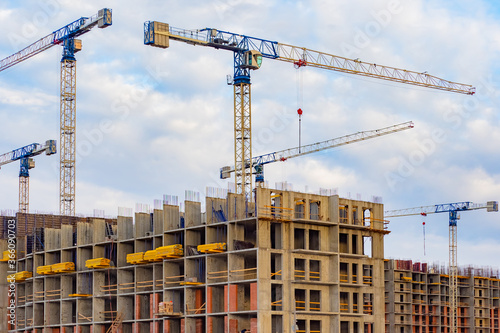 Tower cranes work at a cons...