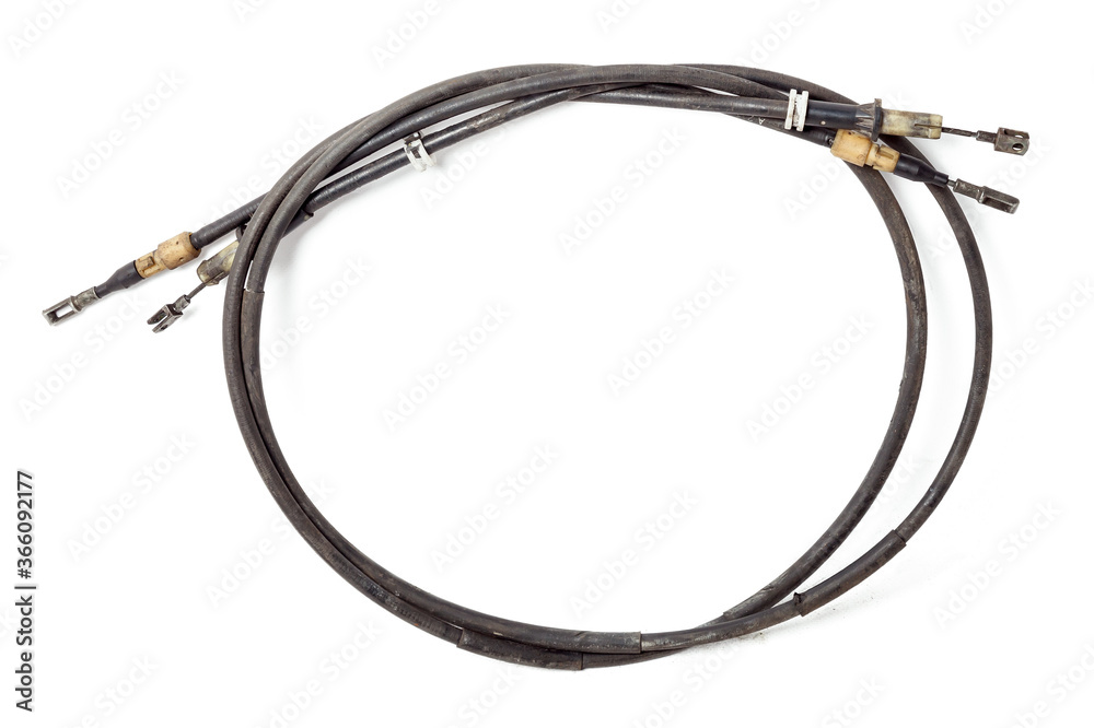Pair of handbrake cables from a car or motorcycle on a white isolated background during repair and replacement in a vehicle service workshop. Spare parts catalog. Pair of handbrake cables from a car or motorcycle on a white isolated background during repair and replacement in a vehicle service workshop. Spare parts catalog.