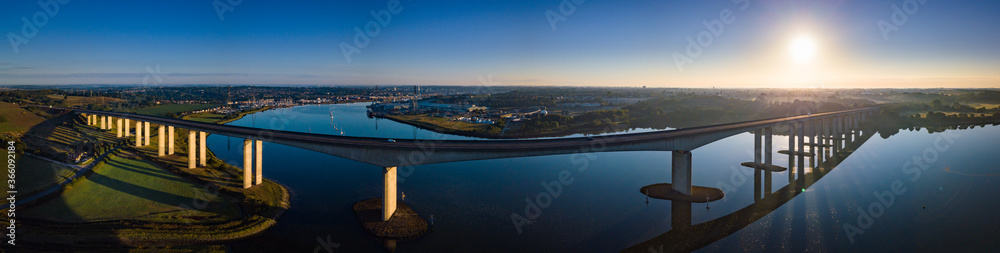 Aerial panorama of Orwell Bridge with sunrise and Ipswich city in the background. Aerial panorama of Orwell Bridge with sunrise and Ipswich city in the background.
