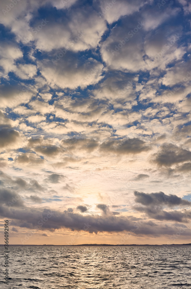 Scenic cloudscape over the sea, color toning applied.