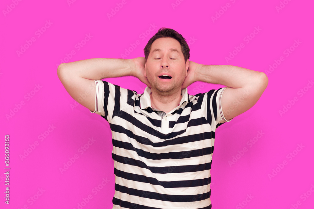 Caucasian man wearing casual striped t-shirt standing over isolated hot pink background shows various gestures.