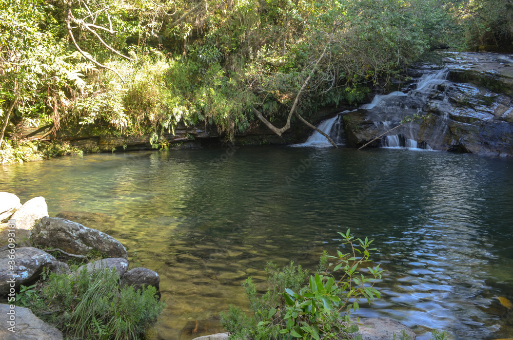 Small waterfall with a beautiful natural pool near a small village in Brazil. Small waterfall with a beautiful natural pool near a small village in Brazil.