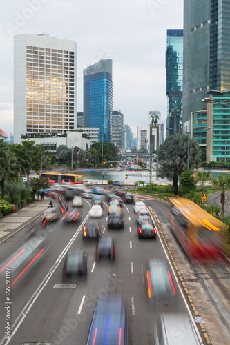 Cars captured with blured motion drive around the Plaza Indonesia roundabout in Jakarta.