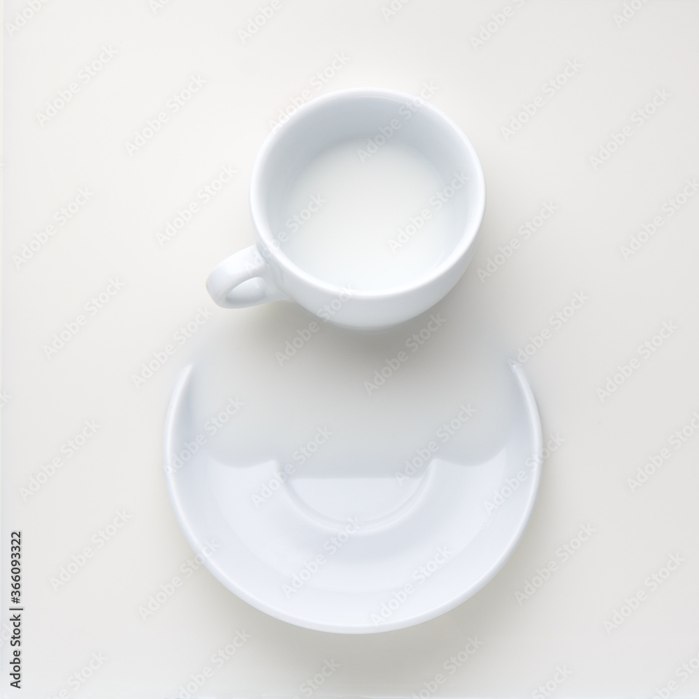white cup and saucer with milk white cup and saucer with milk
