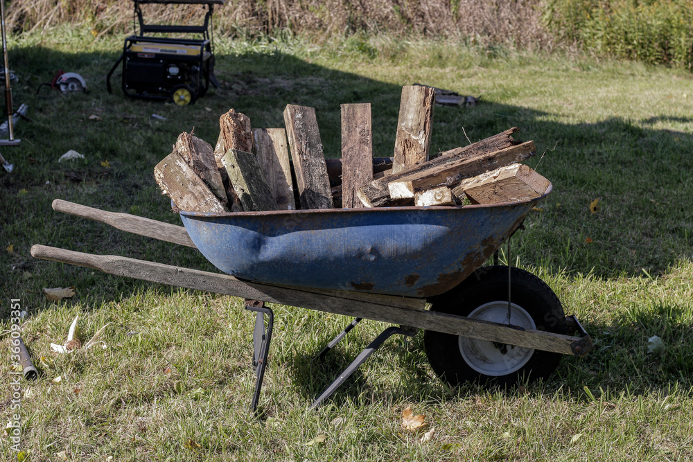 wheelbarrow and firewood Stock Photo | Adobe Stock