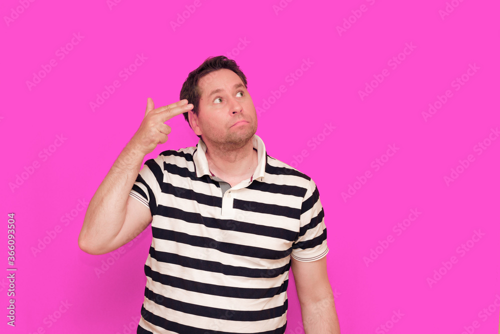 Caucasian man wearing casual striped t-shirt standing over isolated hot pink background shows various gestures. Caucasian man wearing casual striped t-shirt standing over isolated hot pink background shows various gestures.