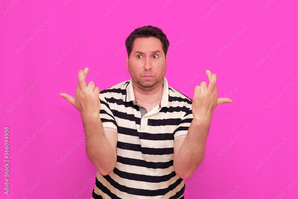 Naklejka premium Caucasian man wearing casual striped t-shirt standing over isolated hot pink background shows various gestures.