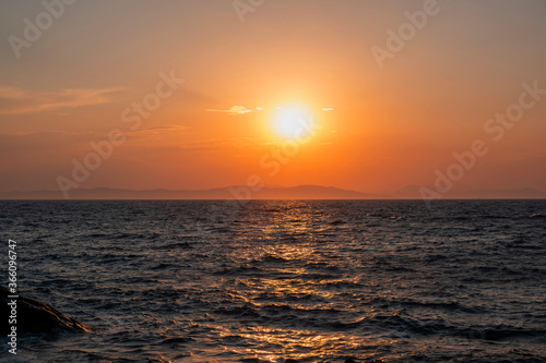 Sunrise  sunset. Twilight  dusk sky over sea water  mountain silhouette