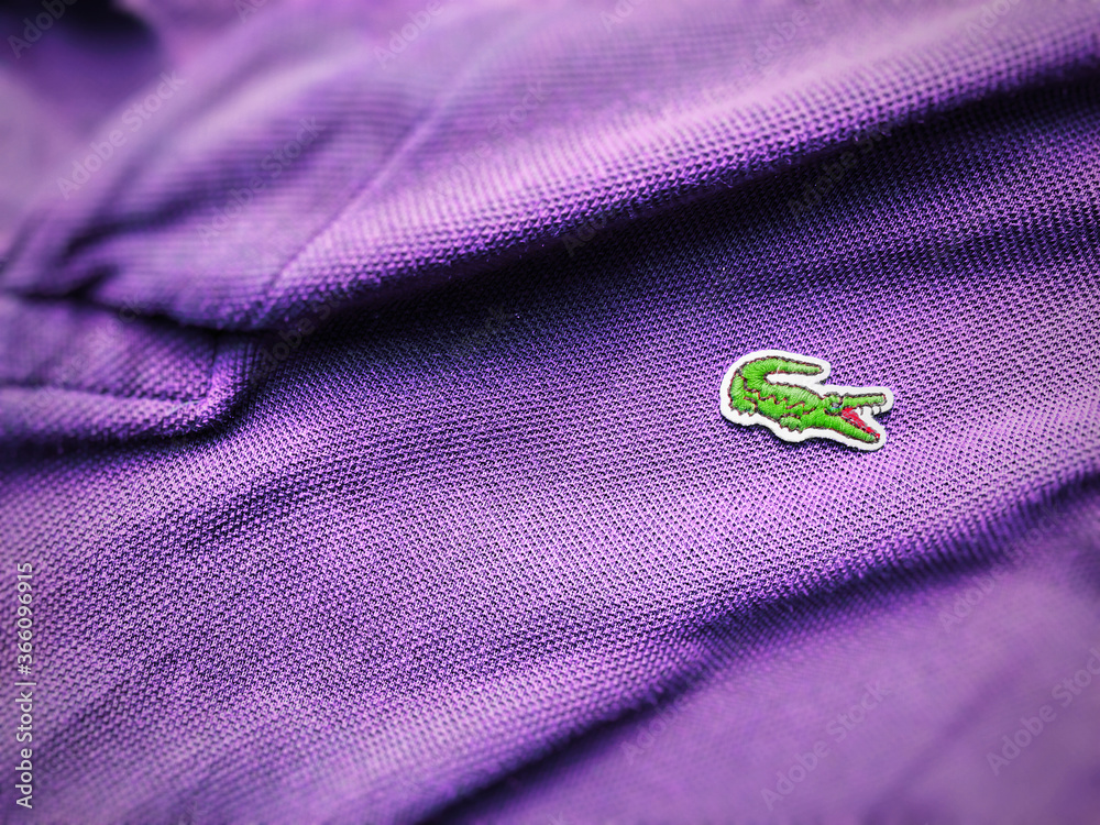 close up view of a Lacoste purple polo shirt. Focus on the sewn crocodile  Stock Photo | Adobe Stock