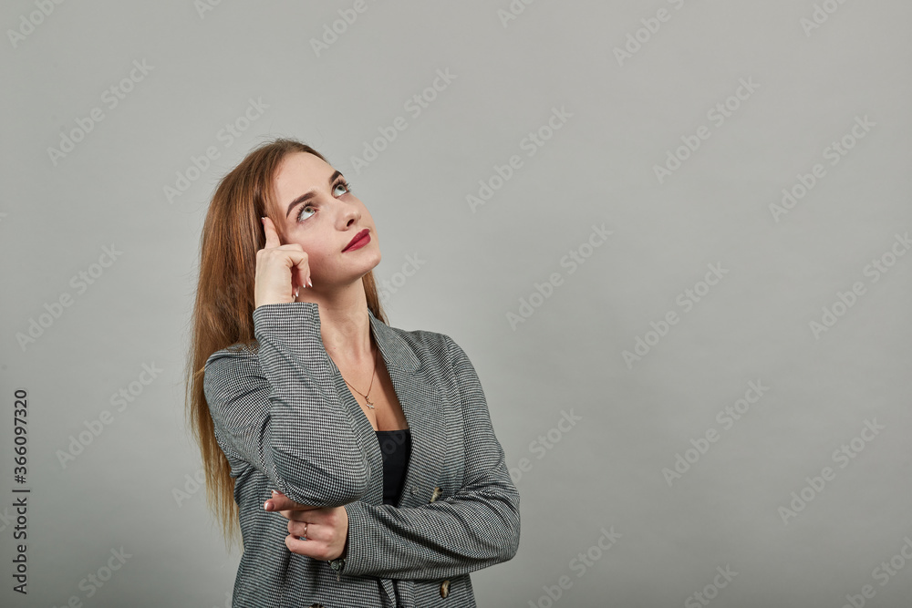 Got head on hand thinking about question, pensive expression. Doubt. Thoughtful face. Using that incredibly sharp business mind. Young attractive woman, dressed gray jacket, with green eyes Got head on hand thinking about question, pensive expression. Doubt. Thoughtful face. Using that incredibly sharp business mind. Young attractive woman, dressed gray jacket, with green eyes