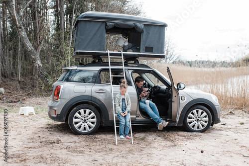 family camping by the beach in roof top tent photo