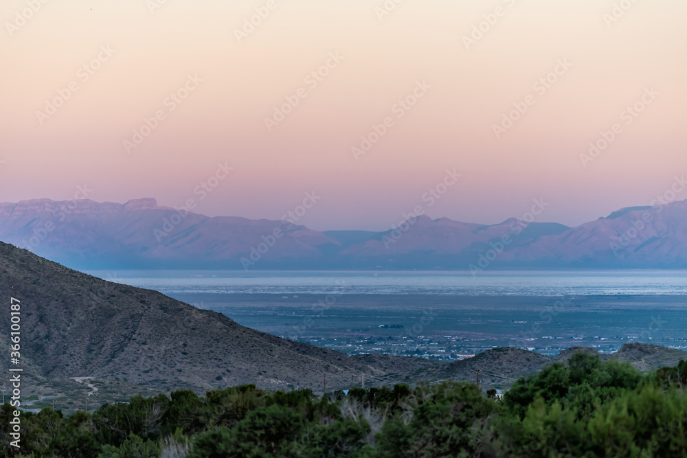 La Luz, New Mexico town view of Organ Mountains and White Sands Dunes National Monument at twilight sunset high angle above perspective with horizon La Luz, New Mexico town view of Organ Mountains and White Sands Dunes National Monument at twilight sunset high angle above perspective with horizon
