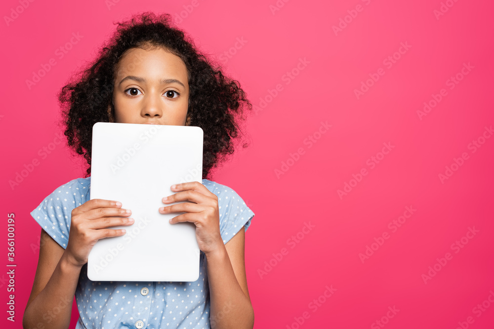 cute curly african american kid holding digital tablet isolated on pink cute curly african american kid holding digital tablet isolated on pink