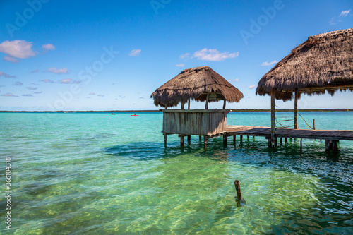 Laguna de Bacalar is also known as the Lagoon of Seven Colors, in Bacalar, Mexico. The crystal clear waters and white sandy bottom of the lake cause the water color to morph into different Colors.