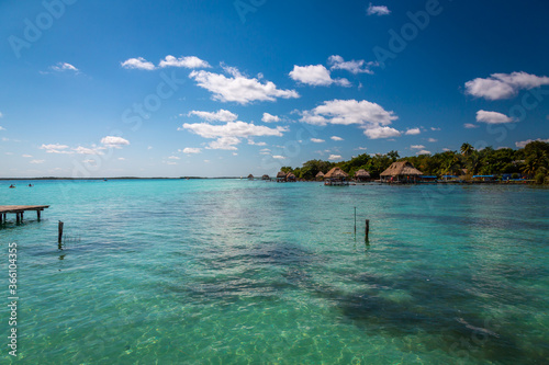 Laguna de Bacalar is also known as the Lagoon of Seven Colors, in Bacalar, Mexico. The crystal clear waters and white sandy bottom of the lake cause the water color to morph into different Colors.