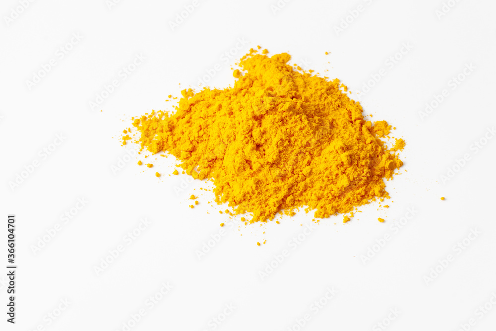 A pile of turmeric spice powder on a white background. A pile of turmeric spice powder on a white background.