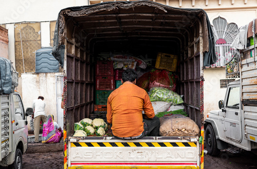 A local seller in market counting his products