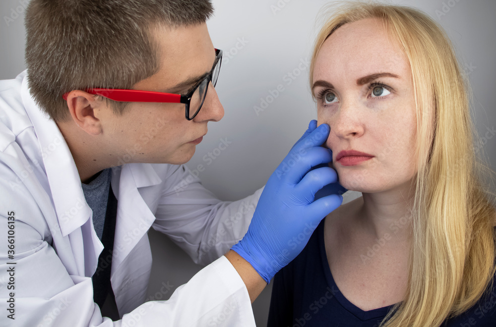 An ophthalmologist examines a woman who complains of a burning