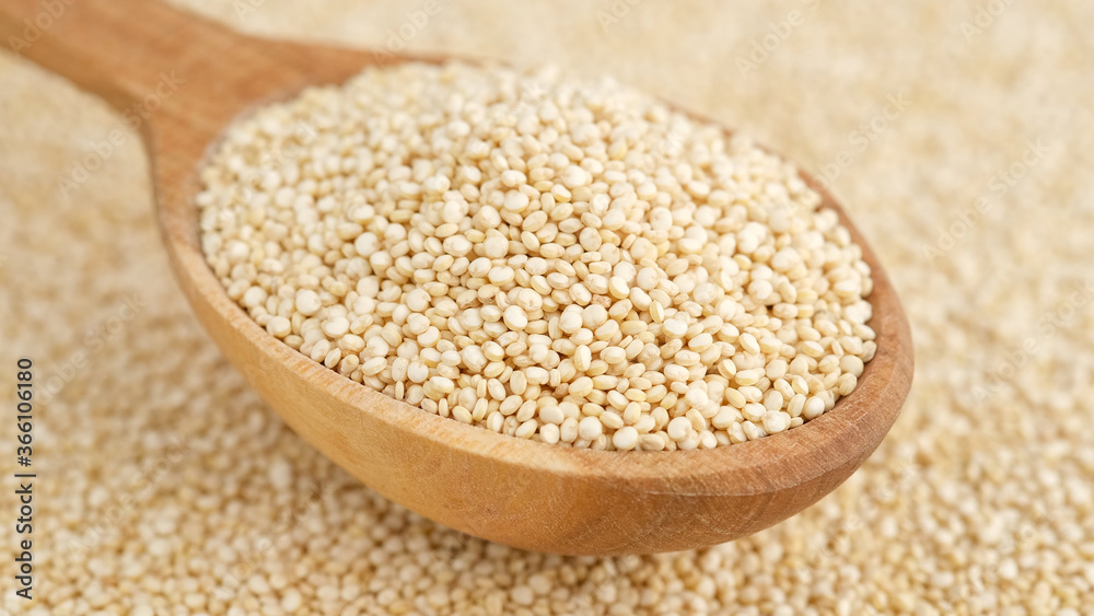 quinoa seeds in wooden spoon and on background. top view quinoa seeds in wooden spoon and on background. top view