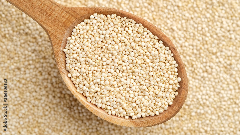 quinoa seeds in wooden spoon and on background. top view quinoa seeds in wooden spoon and on background. top view