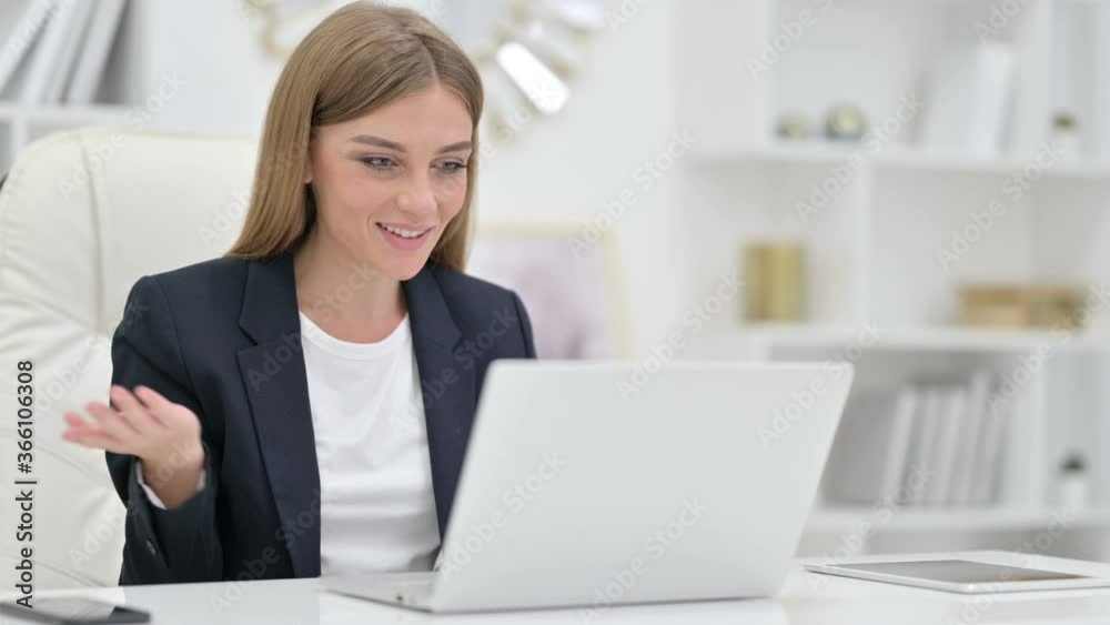 Businesswoman doing Video Call on Laptop in Office Businesswoman doing Video Call on Laptop in Office