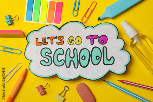 Text Let's go to school and school supplies on yellow background