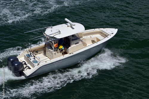 Angled overhead view of a high-end one sport fishing boat with a canopied center console.