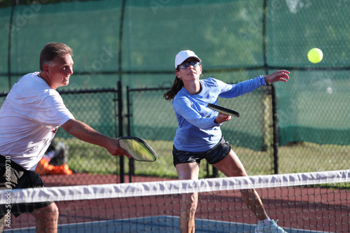 Pickleball net action during a mixed doubles match