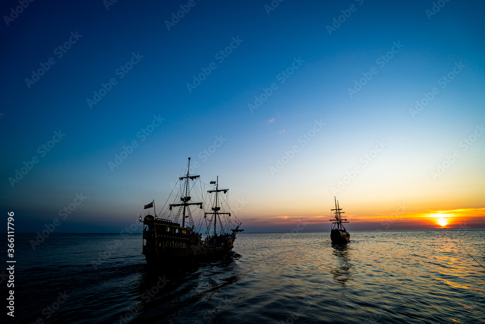 Ships in the sea at sunset