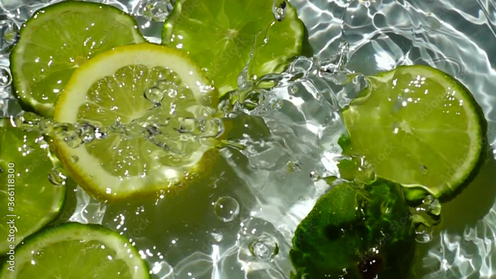 Falling of segments of a lemon and lime. Slow motion.
