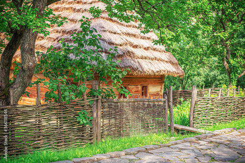 Old wooden house in the countryside. House of a villager in the national style. photo