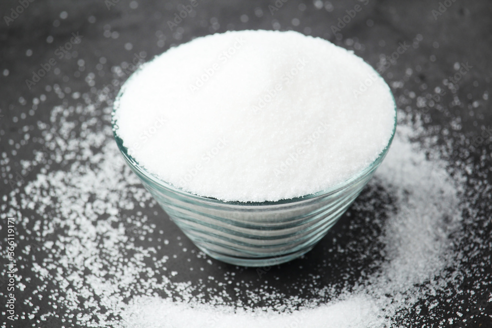 A glass bowl with white sugar A glass bowl with white sugar